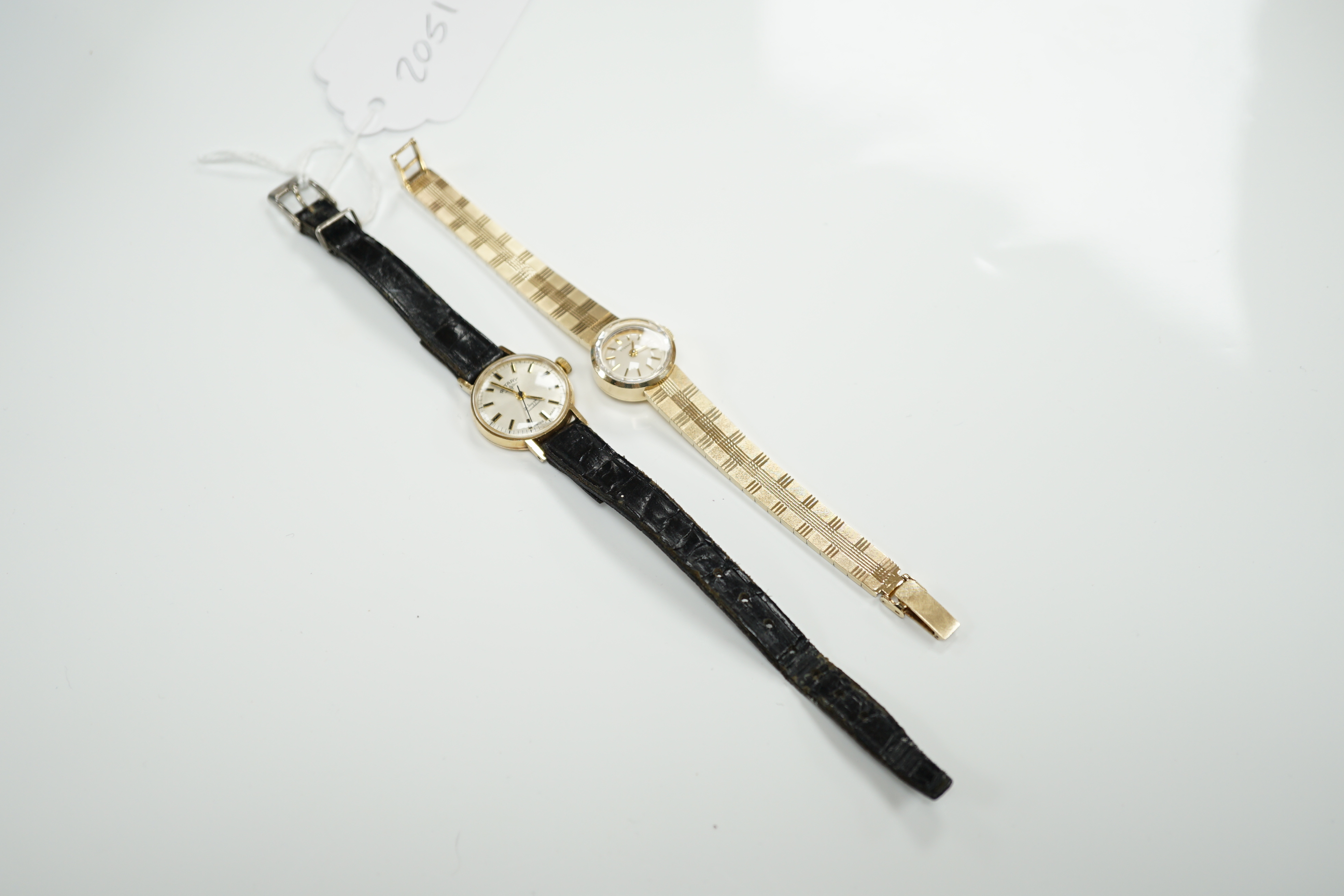 A lady's 9ct gold Eterna manual wind wrist watch, on a 9ct gold integral bracelet, overall 16.2cm, gross weight 23.7 grams, together with a lady's 9ct gold Rotary manual wind wrist watch, on a leather strap.